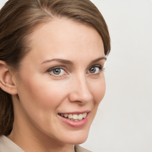 Joyful white young-adult female with medium  brown hair and grey eyes