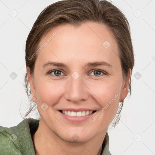 Joyful white young-adult female with medium  brown hair and grey eyes