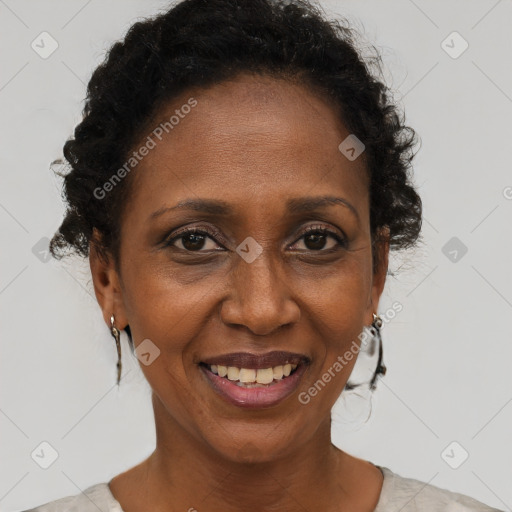 Joyful black adult female with short  brown hair and brown eyes