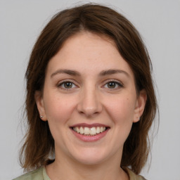 Joyful white young-adult female with medium  brown hair and grey eyes