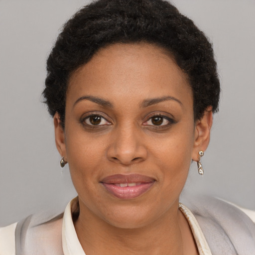 Joyful black young-adult female with short  brown hair and brown eyes