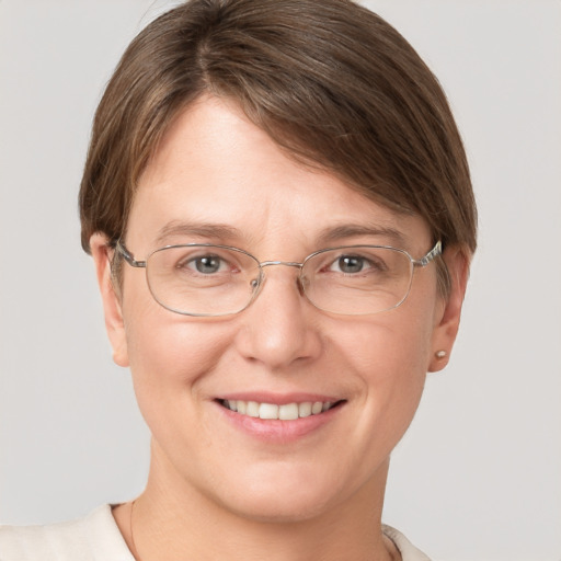 Joyful white adult female with short  brown hair and grey eyes