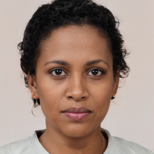 Neutral black young-adult female with short  brown hair and brown eyes
