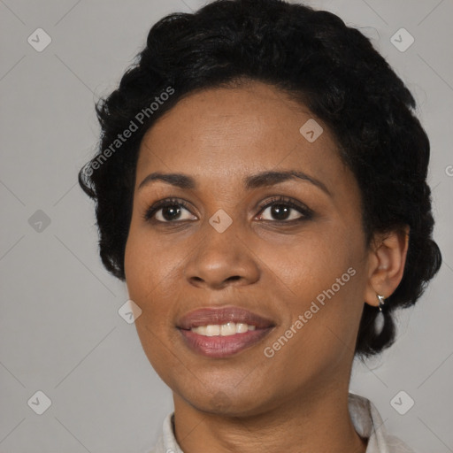 Joyful black adult female with short  black hair and brown eyes