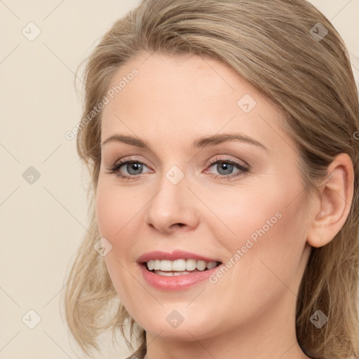 Joyful white young-adult female with long  brown hair and blue eyes