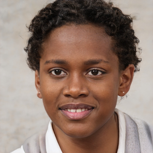 Joyful black child female with short  brown hair and brown eyes