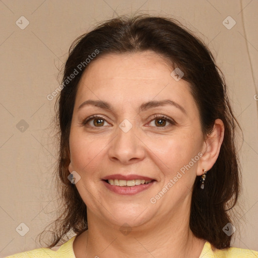 Joyful white adult female with medium  brown hair and brown eyes