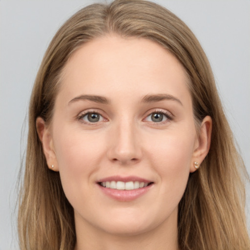 Joyful white young-adult female with long  brown hair and grey eyes