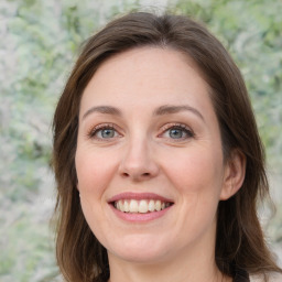 Joyful white young-adult female with medium  brown hair and green eyes