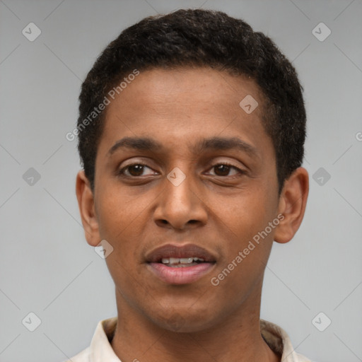 Joyful latino young-adult male with short  brown hair and brown eyes