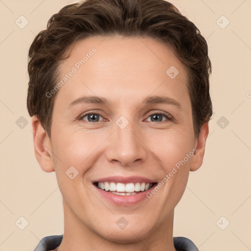 Joyful white young-adult female with short  brown hair and grey eyes