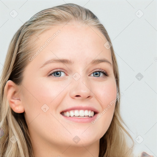 Joyful white young-adult female with long  brown hair and blue eyes