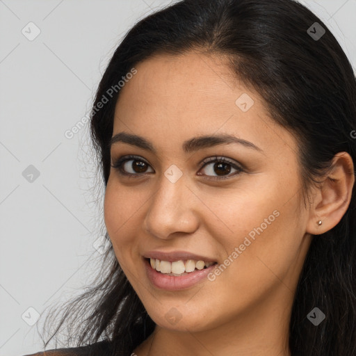 Joyful latino young-adult female with long  brown hair and brown eyes