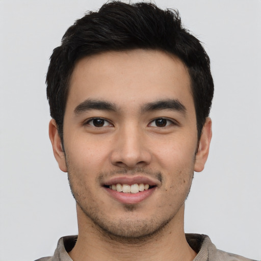 Joyful asian young-adult male with short  black hair and brown eyes
