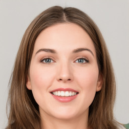 Joyful white young-adult female with long  brown hair and green eyes