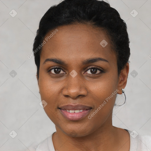 Joyful black young-adult female with short  black hair and brown eyes