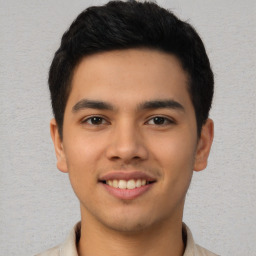 Joyful latino young-adult male with short  black hair and brown eyes