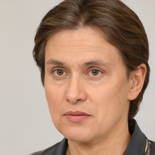 Joyful white adult female with medium  brown hair and grey eyes