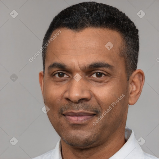 Joyful latino adult male with short  black hair and brown eyes