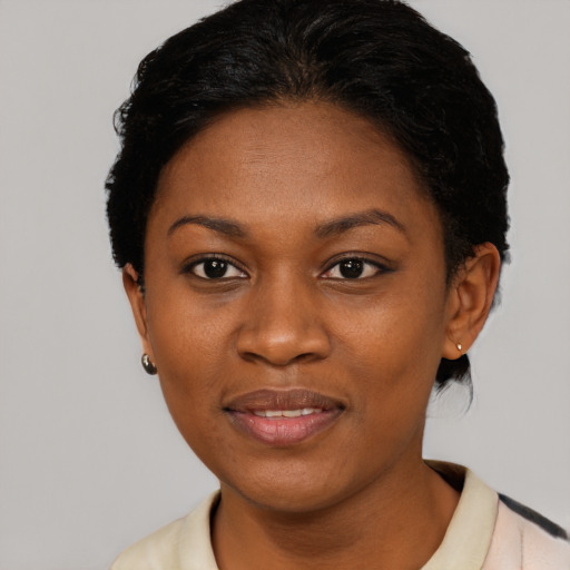 Joyful black young-adult female with short  black hair and brown eyes