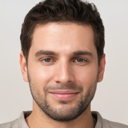 Joyful white young-adult male with short  brown hair and brown eyes