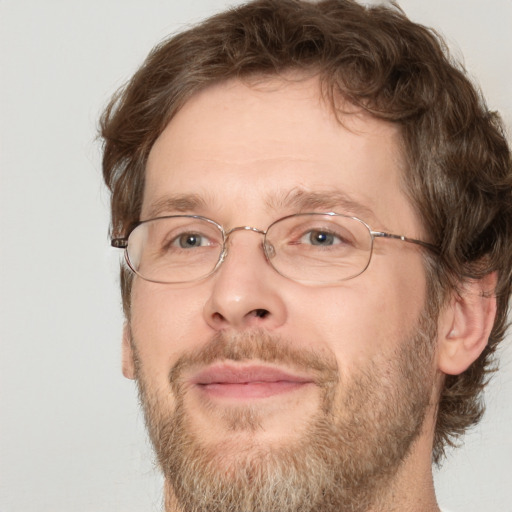 Joyful white adult male with short  brown hair and green eyes