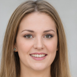 Joyful white young-adult female with long  brown hair and green eyes