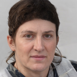 Joyful white adult female with medium  brown hair and grey eyes