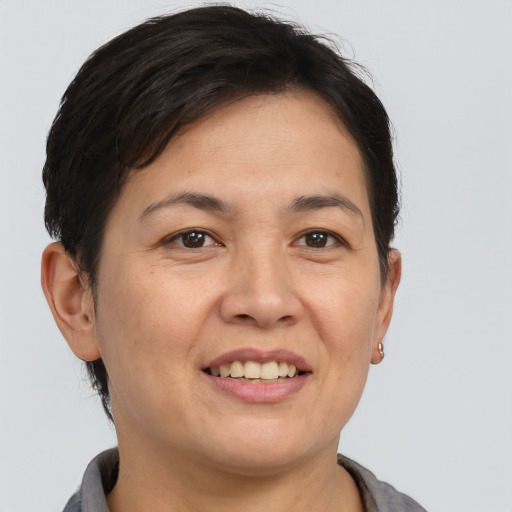Joyful white adult female with short  brown hair and brown eyes