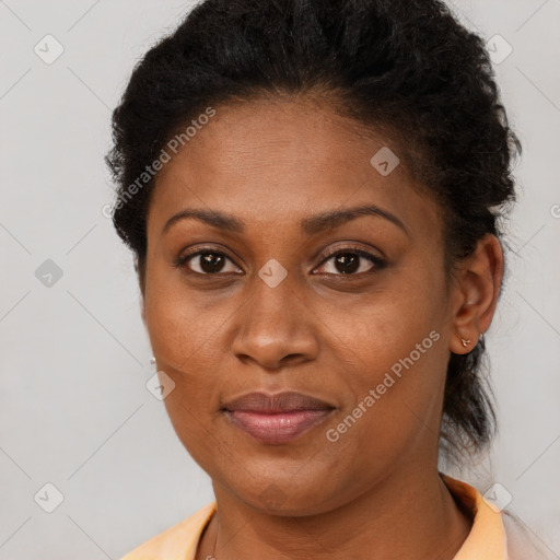 Joyful black young-adult female with medium  brown hair and brown eyes