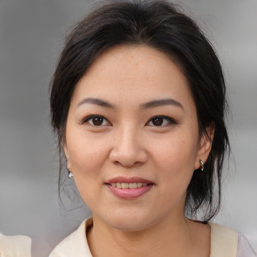 Joyful asian young-adult female with medium  brown hair and brown eyes