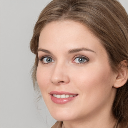 Joyful white young-adult female with long  brown hair and grey eyes