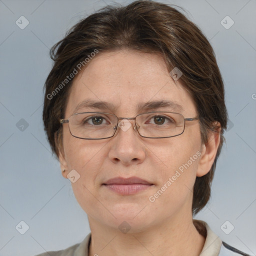 Joyful white adult female with medium  brown hair and grey eyes