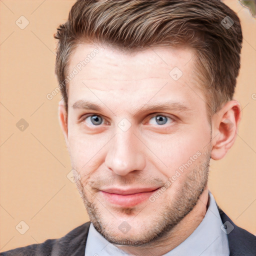 Joyful white young-adult male with short  brown hair and grey eyes