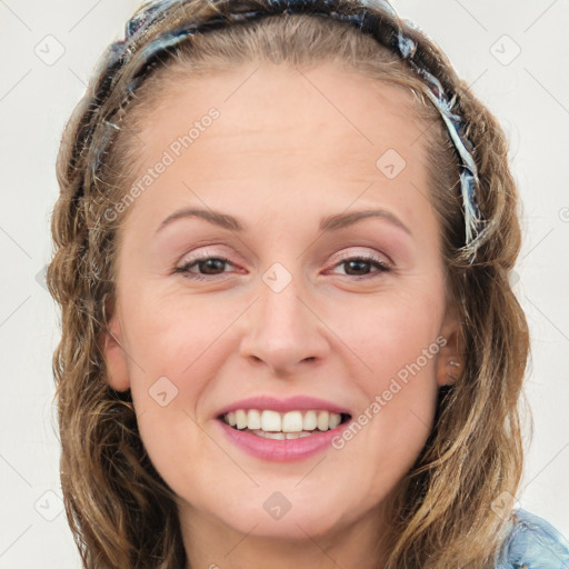 Joyful white young-adult female with long  brown hair and blue eyes