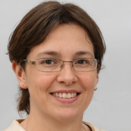 Joyful white adult female with medium  brown hair and brown eyes