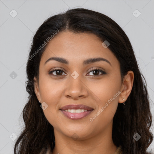 Joyful latino young-adult female with long  brown hair and brown eyes