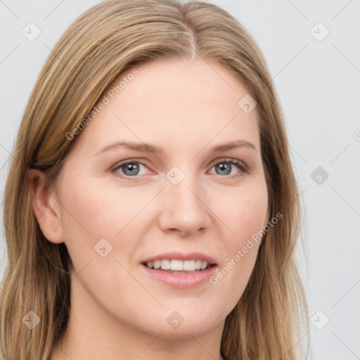 Joyful white young-adult female with long  brown hair and blue eyes