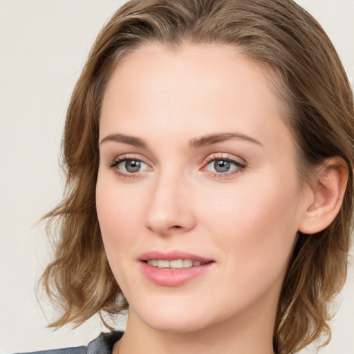 Joyful white young-adult female with long  brown hair and blue eyes