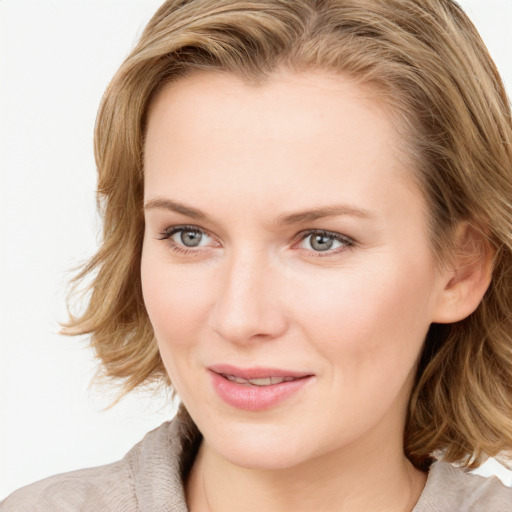 Joyful white young-adult female with medium  brown hair and blue eyes