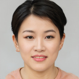 Joyful asian young-adult female with short  brown hair and brown eyes