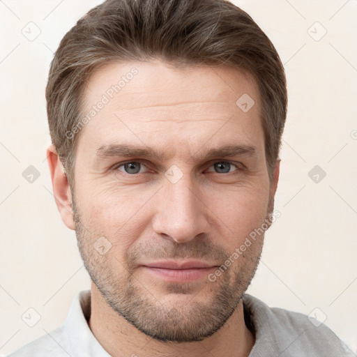 Joyful white adult male with short  brown hair and grey eyes