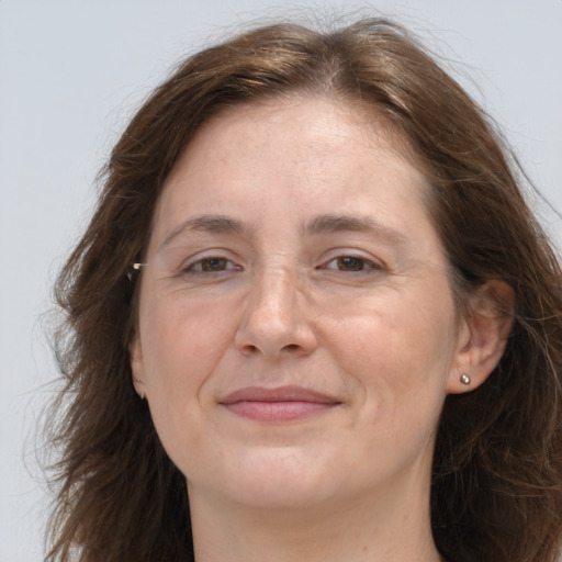 Joyful white adult female with long  brown hair and brown eyes