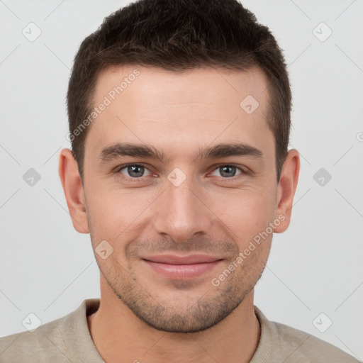 Joyful white young-adult male with short  brown hair and brown eyes