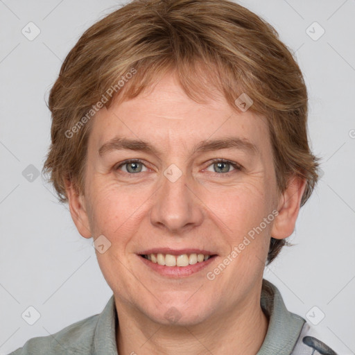 Joyful white adult female with short  brown hair and grey eyes