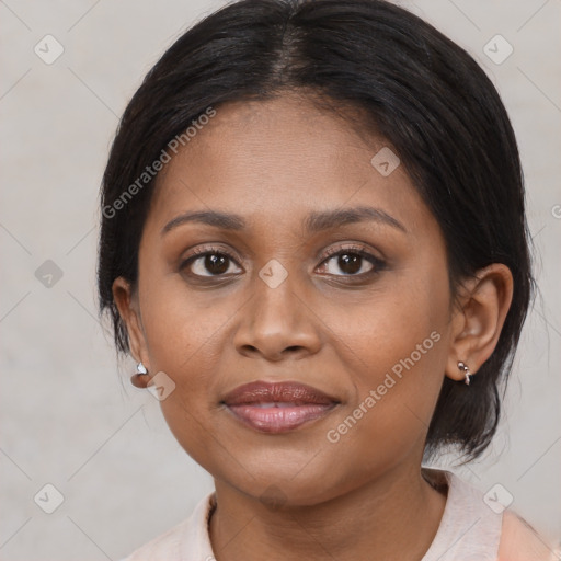 Joyful black young-adult female with medium  brown hair and brown eyes