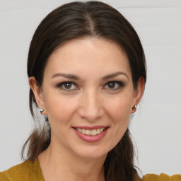 Joyful white young-adult female with medium  brown hair and brown eyes