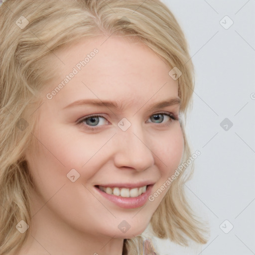 Joyful white young-adult female with long  blond hair and blue eyes