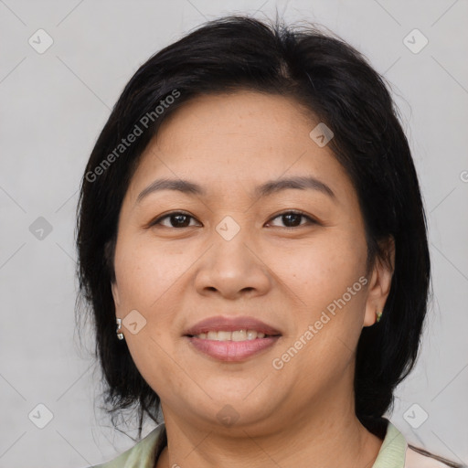 Joyful latino adult female with medium  brown hair and brown eyes