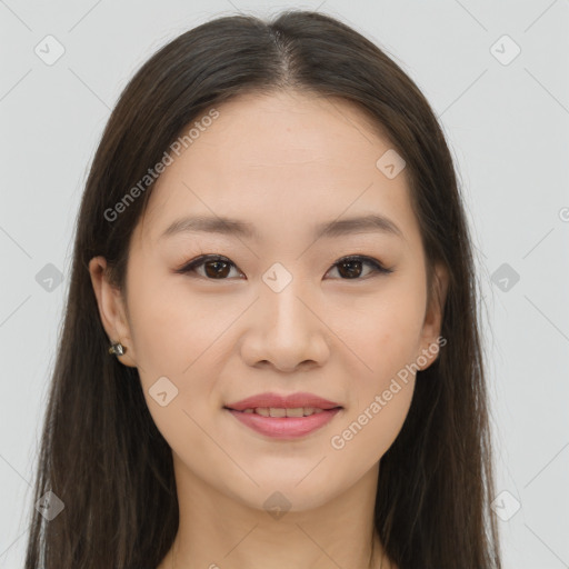 Joyful asian young-adult female with long  brown hair and brown eyes